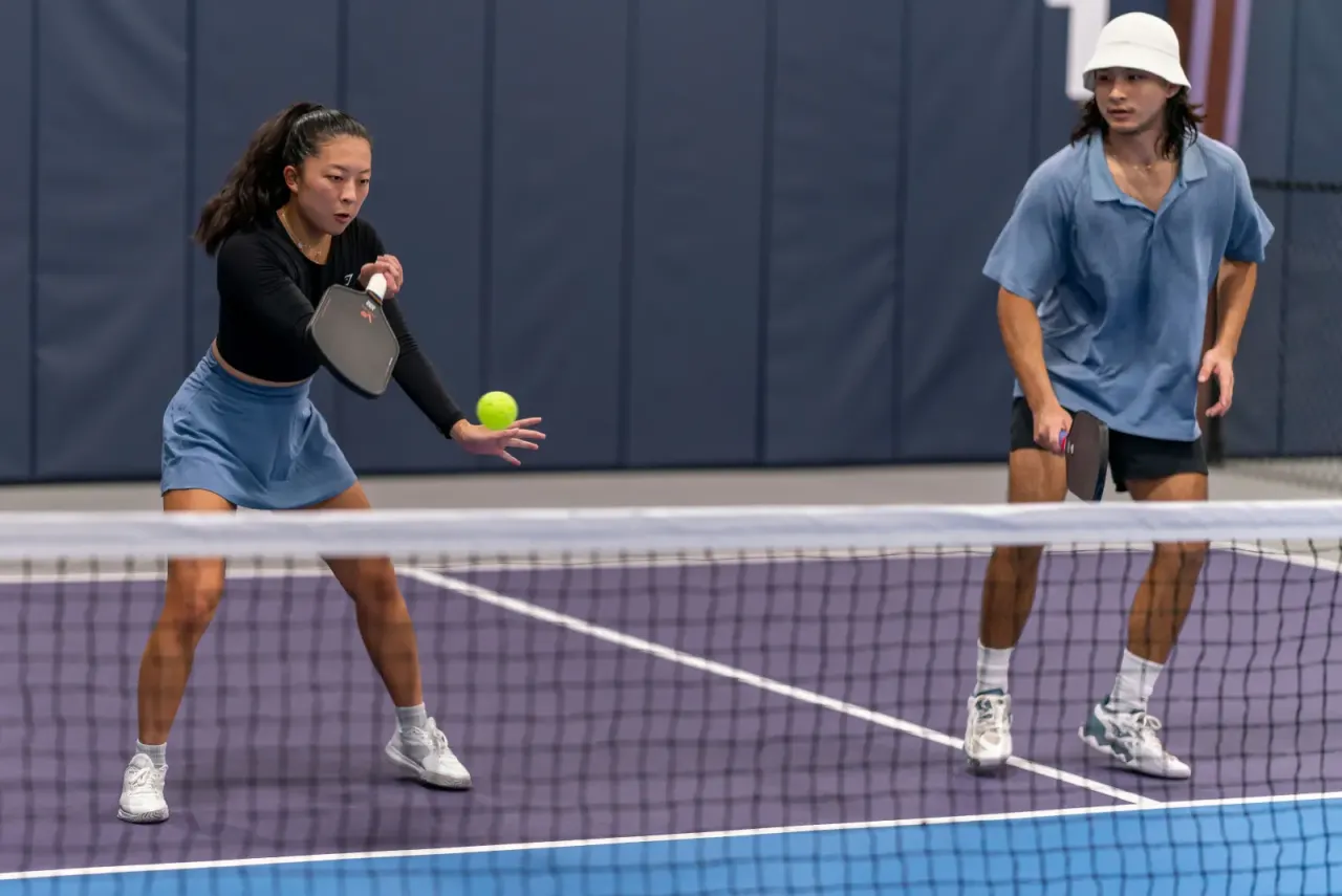 Player hitting a crosscourt dink in mixed doubles at Pickleland