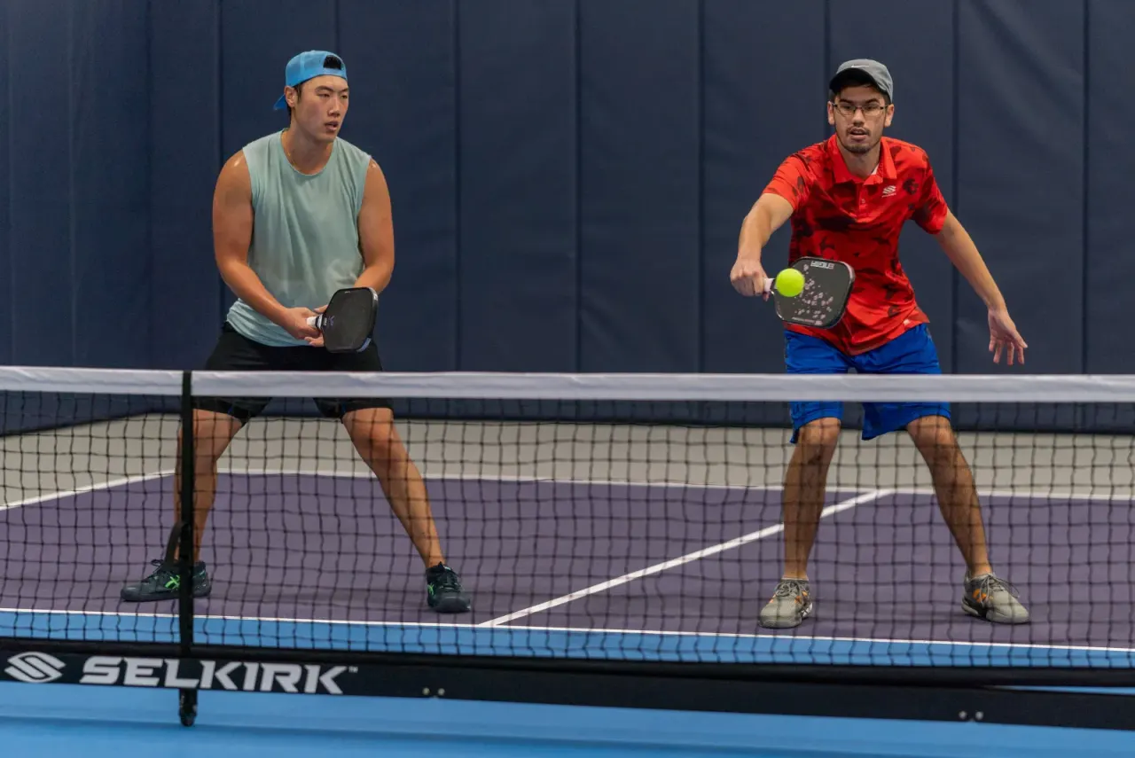 Competitive doubles net play on a Pickleland court
