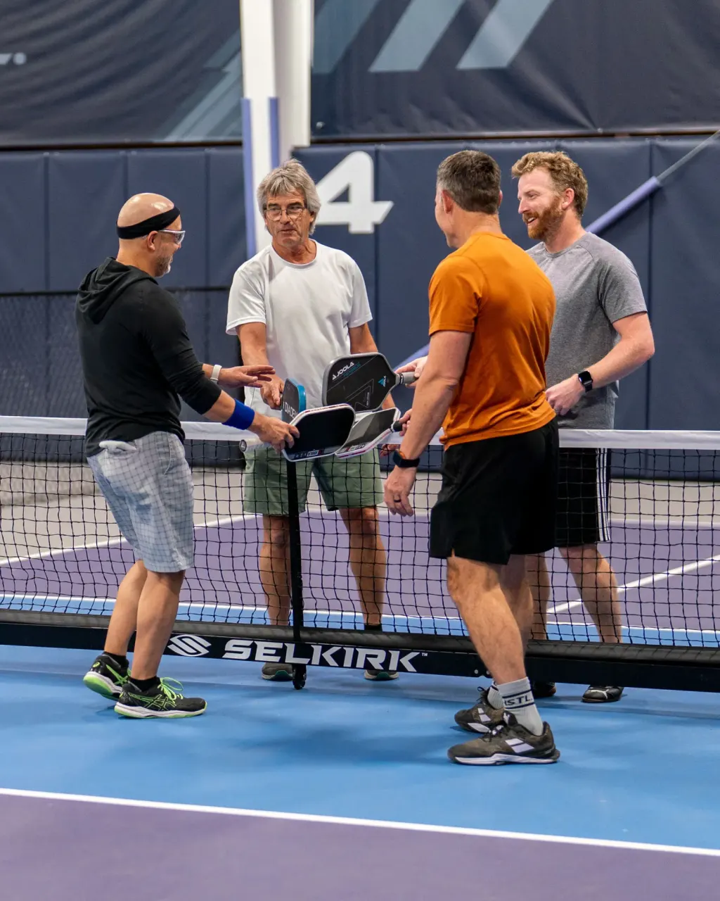 Players chatting at the net between singles games