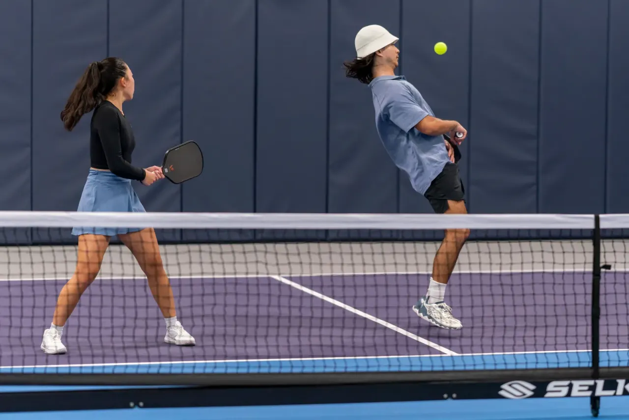 Players in action at the net during a rally