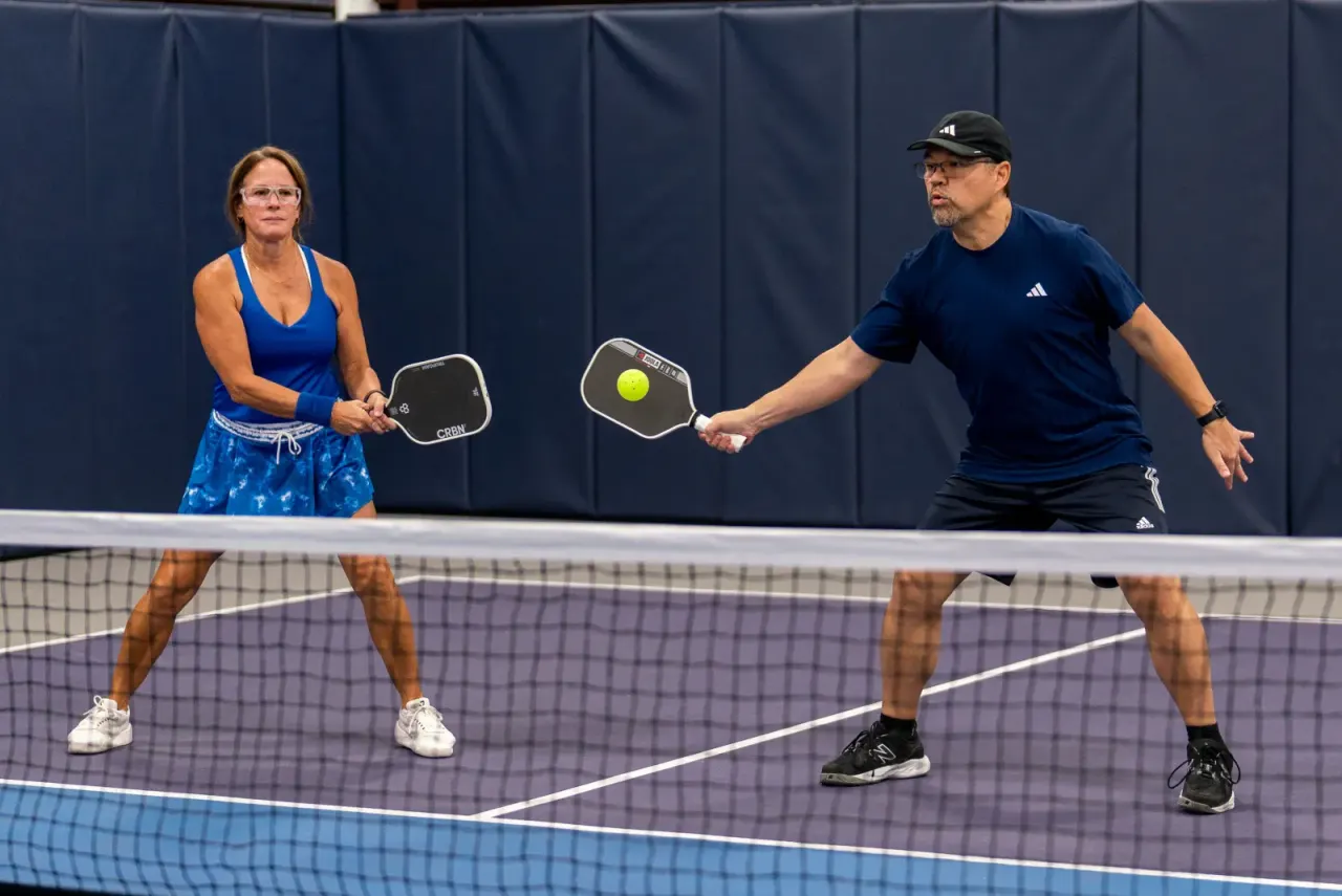 Mixed doubles net play at Pickleland