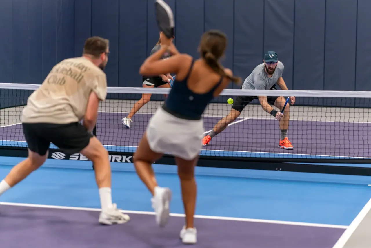 Doubles partners covering the court together at Pickleland