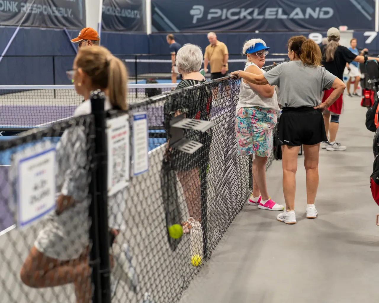 Players chatting and laughing at the net between games
