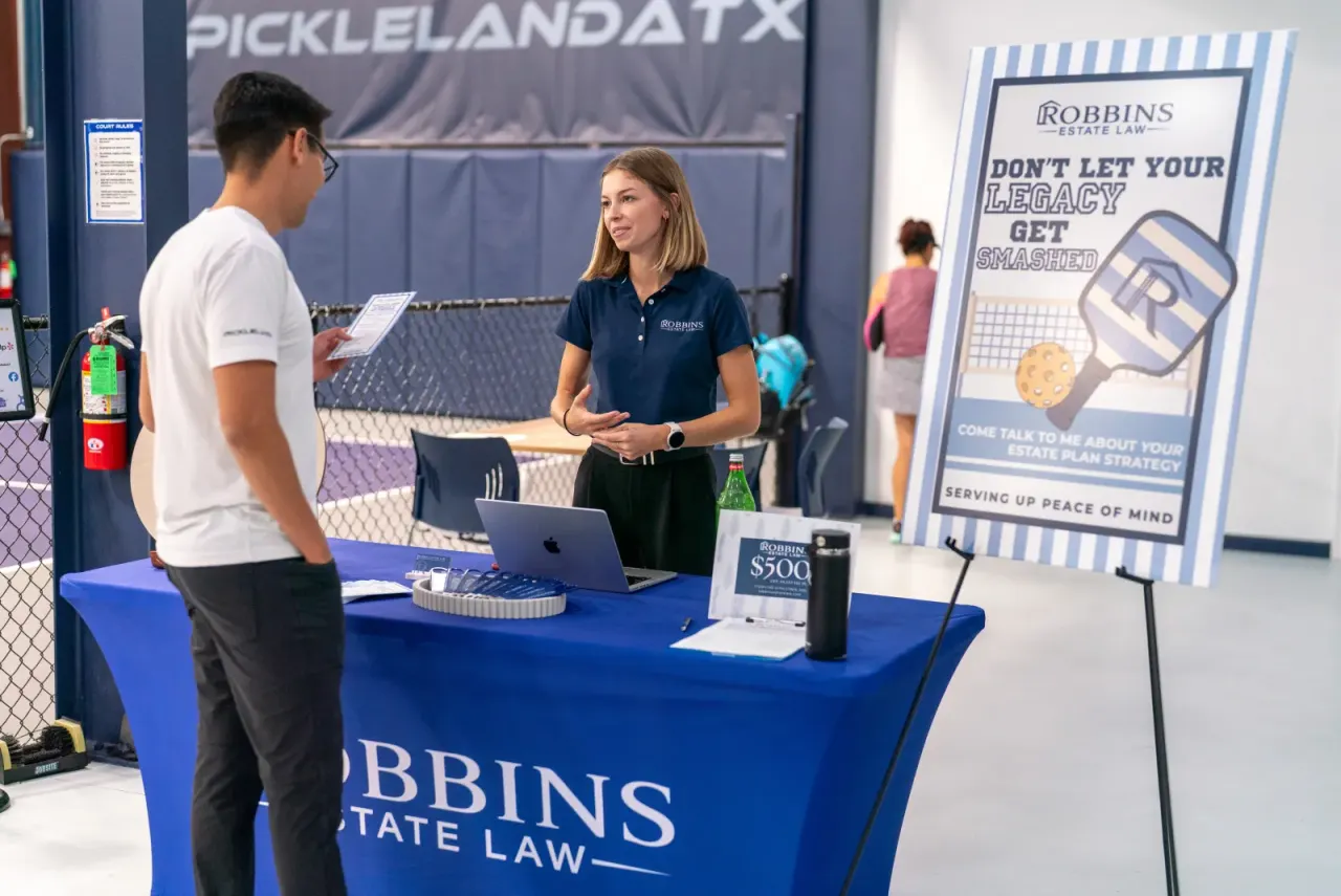 Sponsor expo booth (Robbins Estate Law) at a Pickleland event