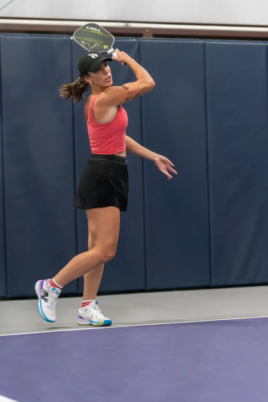 Player hitting an overhead smash at Pickleland