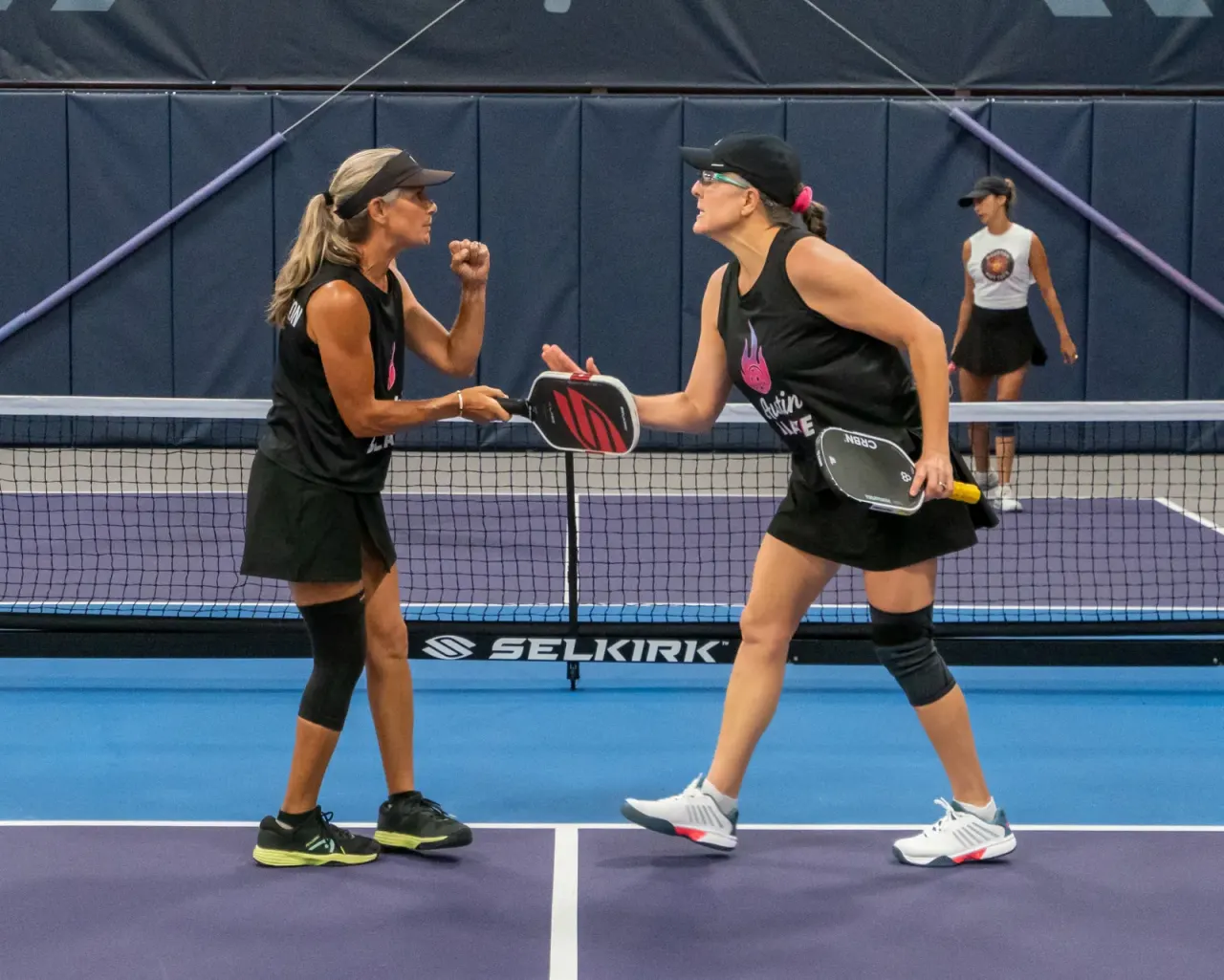 Players high-fiving and celebrating a point