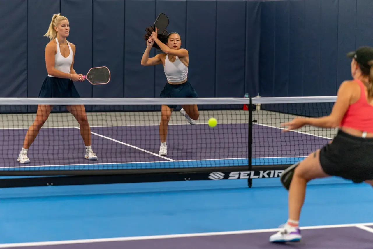 Pickleland players at the net in a doubles rally