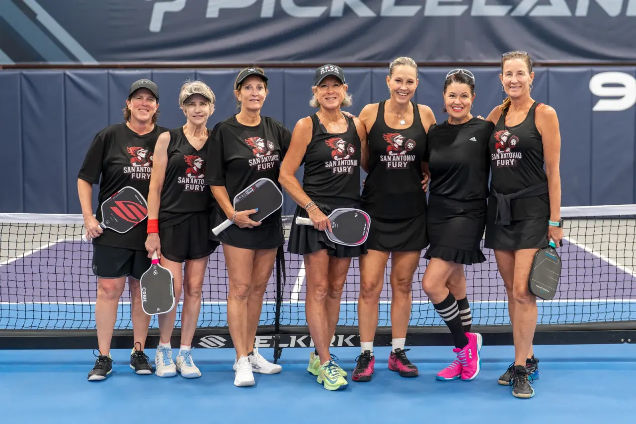Players holding paddles at Pickleland