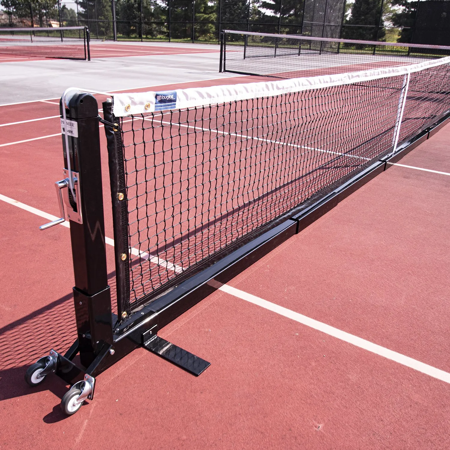 Portable pickleball net set up on an outdoor court, an easy no-install option for a backyard setup