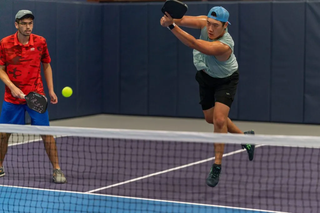 Beginners rallying on a pickleball court during their first session